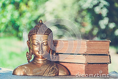 Buddha and books. Buddhism and meditation. Buddha sculpture Stock Photo
