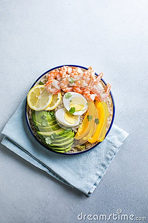 Buddha bowl with avocado, prawns, rice, on light background. Healthy food, clean eating, Buddha bowl, top view Stock Photo