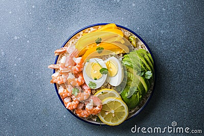 Buddha bowl with avocado, prawns, rice, on light background. Healthy food, clean eating, Buddha bowl, top view Stock Photo