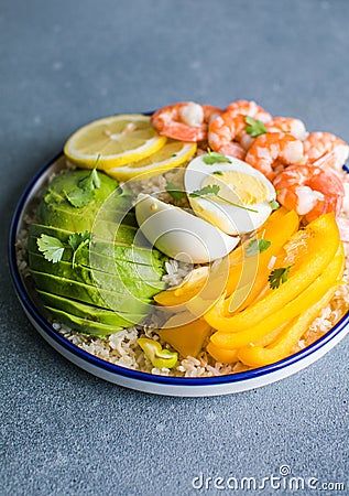Buddha bowl with avocado, prawns, rice, on light background. Healthy food, clean eating, Buddha bowl, top view Stock Photo