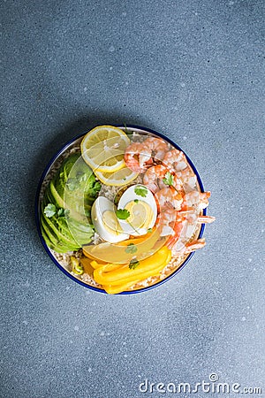 Buddha bowl with avocado, prawns, rice, on light background. Healthy food, clean eating, Buddha bowl, top view Stock Photo