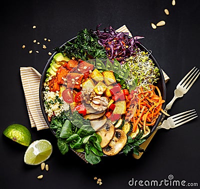 Buddha bowl of mixed vegetables, tofu cheese and groat on a black background. Gourmet and nutritious vegan meal. Stock Photo