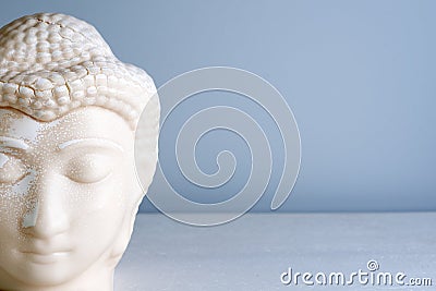Buddha face. Buddha statue made of white marble with free space for text. Concept of peace, calm and tranquility Stock Photo