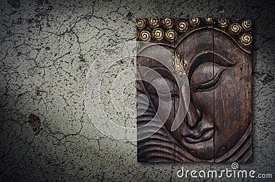 Buddha image in wood graving on the wall Stock Photo