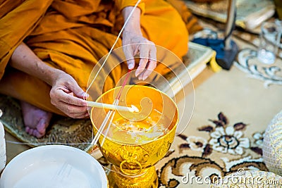 Buddha monk hold candlestick above holy water bowl. religion ceremony. Buddhist holy water. image for copy space. Stock Photo