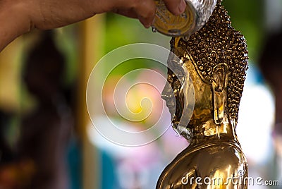 Buddha pour water Stock Photo