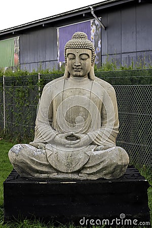 Buddha statue figure sculpture in stone outside Stock Photo