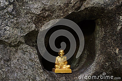 Buddha statue and holy at front of Tham Muang On cave in mountain situated of Mae On for thai people and foreign travelers travel Stock Photo