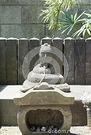 Buddha stone sculpture. A buddha stone sculpture with a snake bo Stock Photo