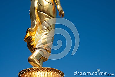 Buddha walking closeup feet statue in Thailand for the way of wisdom to nibbana or nirvana Stock Photo