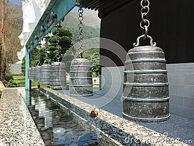 Buddhist bronze bells over water Stock Photo