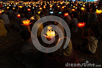 Buddhist hold lanterns and garlands praying at night on Vesak day for celebrating Buddha`s birthday in Eastern culture Stock Photo