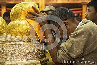 Buddhist Man Praying at Phaung Daw Oo Pagoda, Inle Lake, Myanmar Editorial Stock Photo