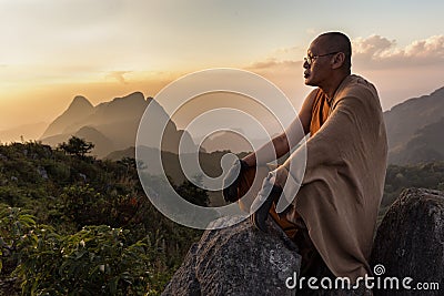 Buddhist master monk meditating in mountains Editorial Stock Photo