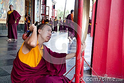 Buddhist Monk playing the gong Editorial Stock Photo