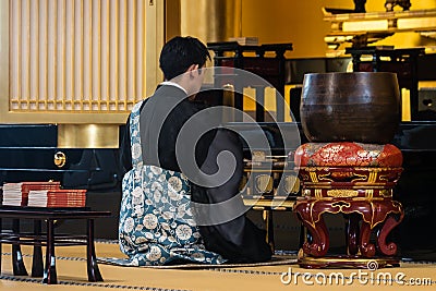 Buddhist monk praying in temple in Tokyo Editorial Stock Photo