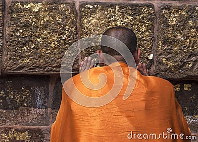 Buddhist monk prays at the Dhamekh Stupa. Editorial Stock Photo