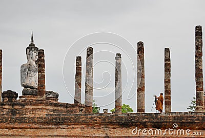 Buddhist monk taking pictures at Wat Mahathat, Sukhothai Thailand. Editorial Stock Photo