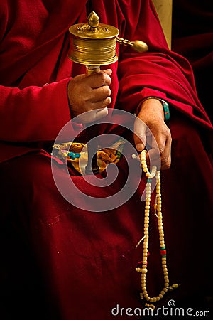 Buddhist monk and wheel, Dalai Lama temple, McLeod Ganj, India Editorial Stock Photo