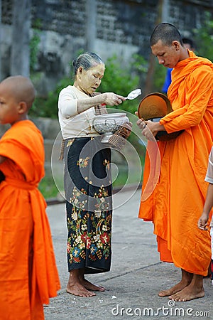 Buddhist monks collecting alms Editorial Stock Photo