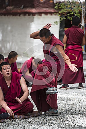 Buddhist monks` debating practice ï¼Œa monk is clapping , drastic debating , Tibet Editorial Stock Photo