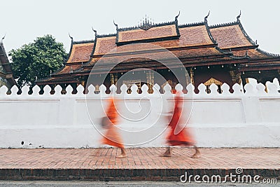 Buddhist monks during Laotian traditional sacred alms giving ceremony in Luang Prabang city, Laos Stock Photo