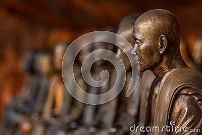 Buddhist monks statues symbol of peace and serenity at Wat Phu Tok temple, Thailand, asceticism and meditation, buddhist art work Stock Photo