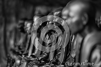 Buddhist monks statues symbol of peace and serenity at Wat Phu Tok temple, Thailand, asceticism and meditation, buddhist art work Stock Photo