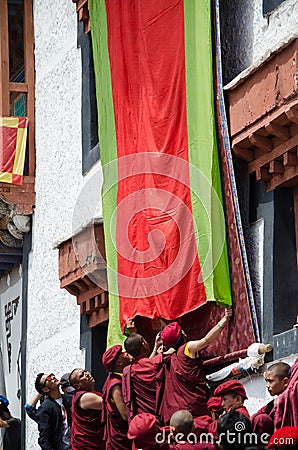 Buddhist Monks unveil the Thangka- A Tibetan Buddhist painting of Lord Padmashambhava Editorial Stock Photo