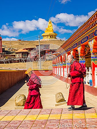 Buddhist monks walking in Yarchen Gar Monastery Editorial Stock Photo