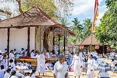 Buddhist pilgrims in the pavilions hall of shrine of Sri Dalada Maligawa or the Temple of the Sacred Tooth Relic, in Kandy, Sri Editorial Stock Photo