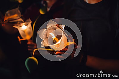 Buddhist praying with incense sticks, lotus flower and candles on holy religion day of Vesak at night. Stock Photo