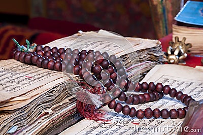 Buddhist religious japa mala on manuscript Stock Photo