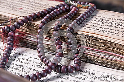 Buddhist religious japa mala on manuscript Stock Photo