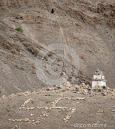 Buddhist stupa and stone swastika cross Stock Photo