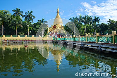 Buddhist temple Maha Wizaya Pagoda. The view from the side of the pond. Yangon, Myanmar Stock Photo