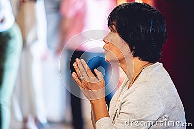 Buddhist woman praying to Buddhist idols with incense near the altar in Hanoi City, Vietnam Editorial Stock Photo