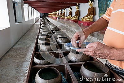 Buddhists are donating money to temple by their faith and to maintain the temple in Thailand. Stock Photo