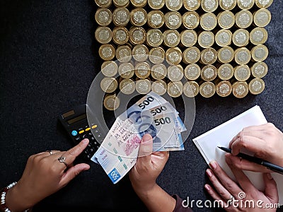 budget and administration, hands of two person counting coins and mexican banknotes Stock Photo