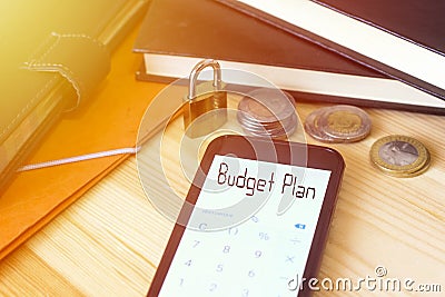 budget plan text on phone calculator with padlock and coin algeria and black book Stock Photo