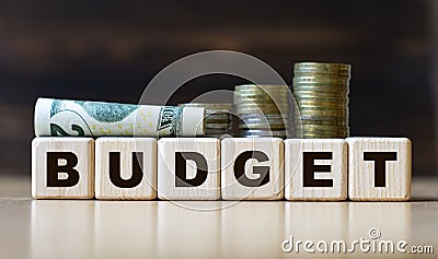 BUDGET - word on diced on a beautiful dark background with coins Stock Photo