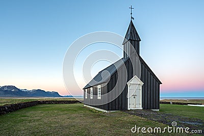 Budir church in Snaefellsness peninsula in the Icelandic countryside near Reykjavik during blue hour and sunset. Stock Photo