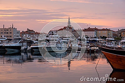 Budva bay sunrise. Panoramic view of marina, boats and old city Editorial Stock Photo