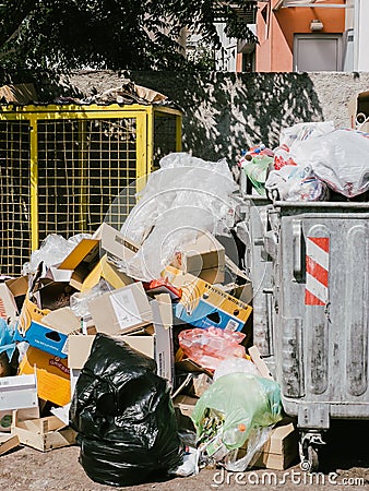 Budva, Montenegro - 05 august 2023: Empty cardboard boxes and plastic waste lie next to an overflowing trash can Editorial Stock Photo