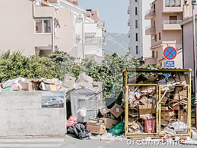 Budva, Montenegro - 05 august 2023: Overflowing trash cans next to high-rise buildings Editorial Stock Photo