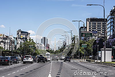 Buenos Aires Avenida 9 de Julio obelisk during the day with advertising signs and automobile traffic Editorial Stock Photo
