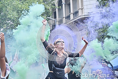 Women waving green and violet smoke flares in the air during 8M feminist strike Editorial Stock Photo