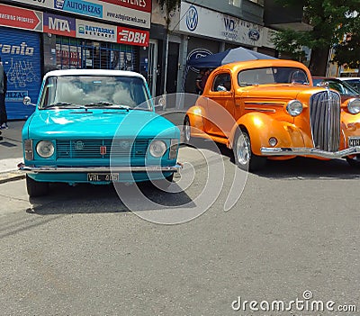 Fiat 128 sedan 1970s beside a Chevy Master 1930s. Expo Warnes 2021 classic car show. Copyspace Editorial Stock Photo