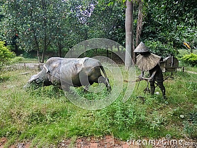 The buffalo plowed the sculpture Stock Photo