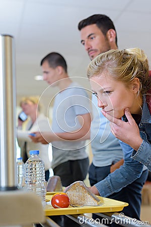 buffet female student in servicing food in cafeteria Stock Photo